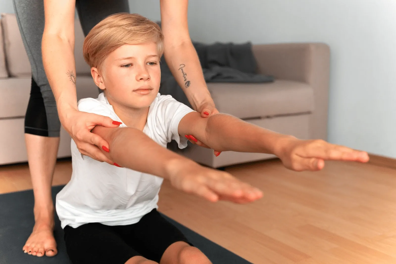 Child practicing movement therapy for coordination and balance with physiotherapist support